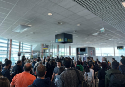 Passengers crowding around a gate at Lisbon Airport