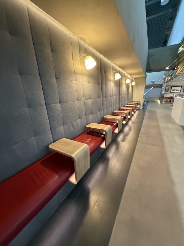 Bench seating around the edges of the American Airlines Lounge