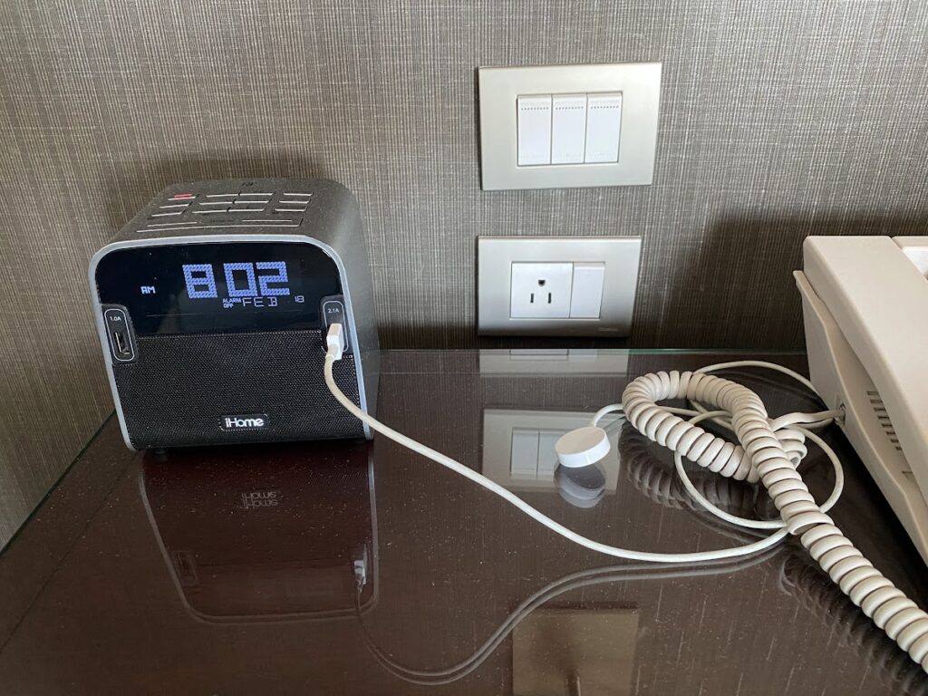 Bedside clock and power outlet in hotel room