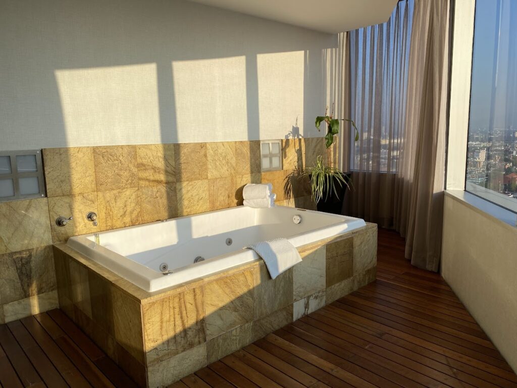 Sunlit marble jacuzzi tub in Hilton Mexico City Reforma suite