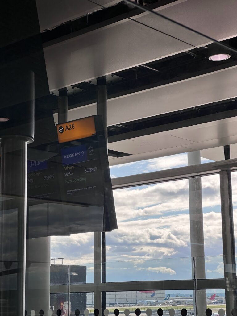 Heathrow gate A26 boarding screen showing Aegean Athens flight