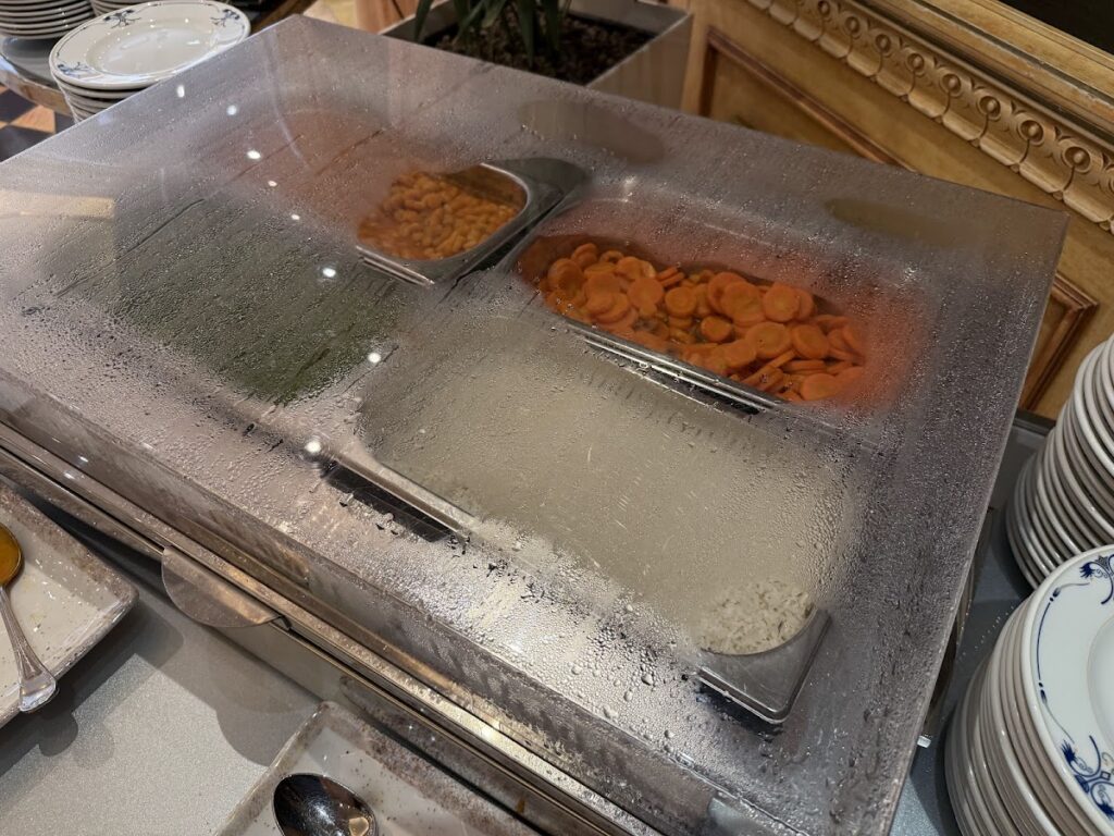 Sparse breakfast buffet hot station with condensation on cover
