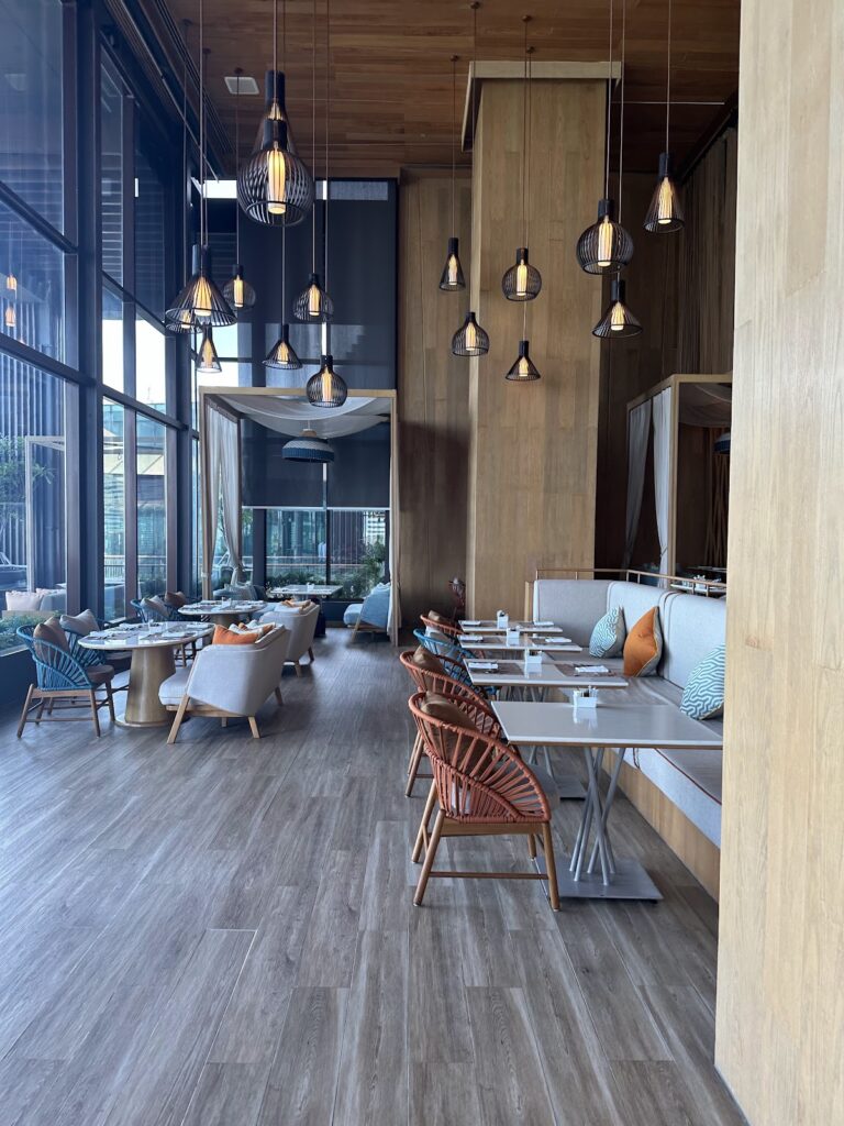 Hilton Pattaya restaurant with pendant lights and rattan chairs