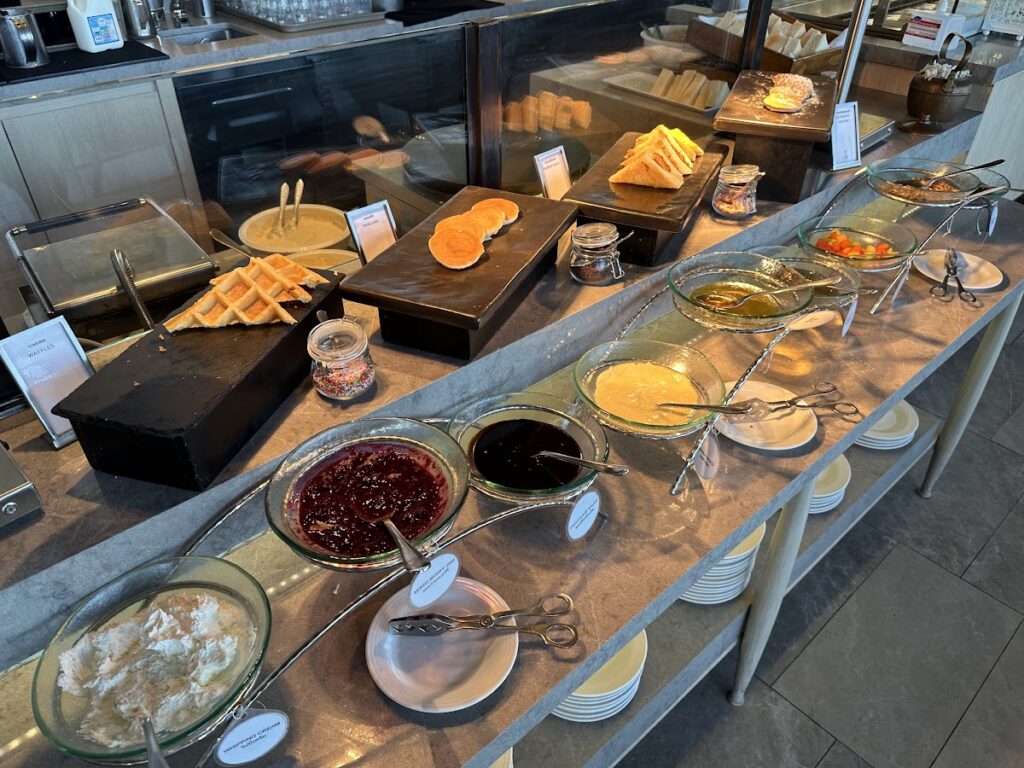 Breakfast buffet spread with waffles and condiments