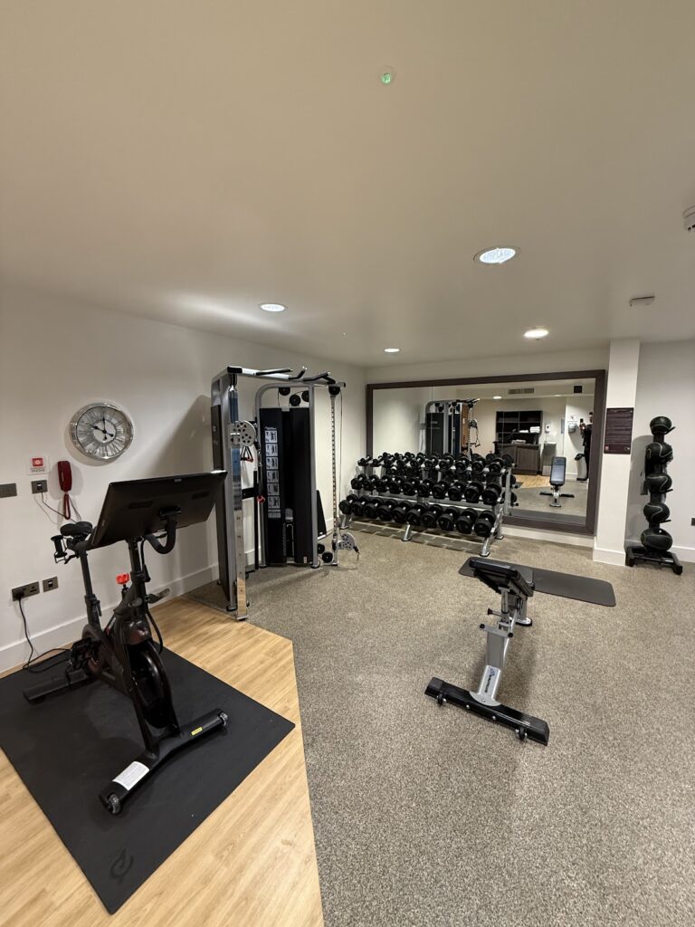 Fitness centre with dumbbells and bike at the hotel