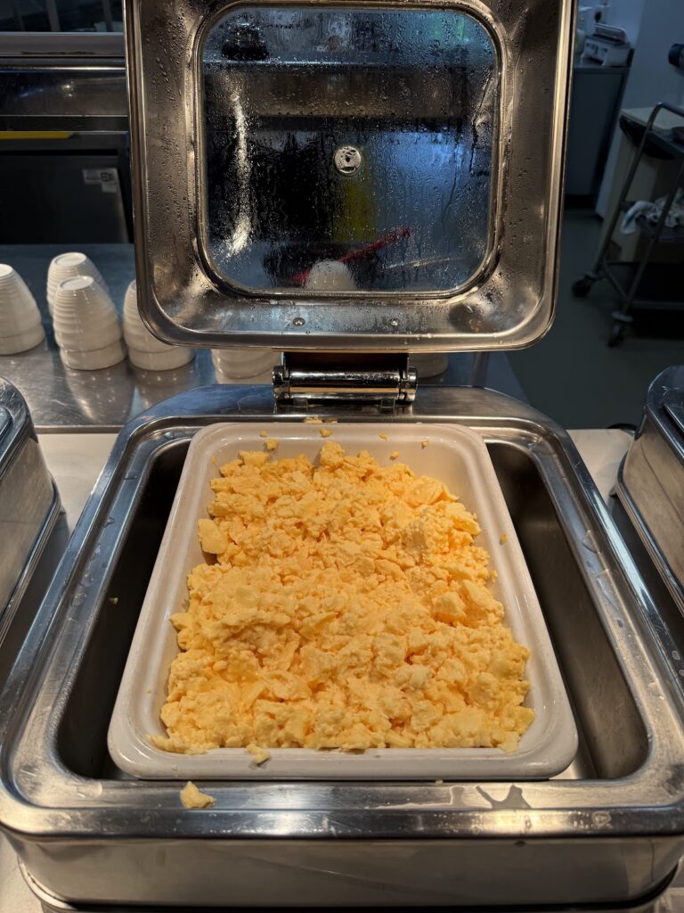 Scrambled eggs in a buffet chafing dish