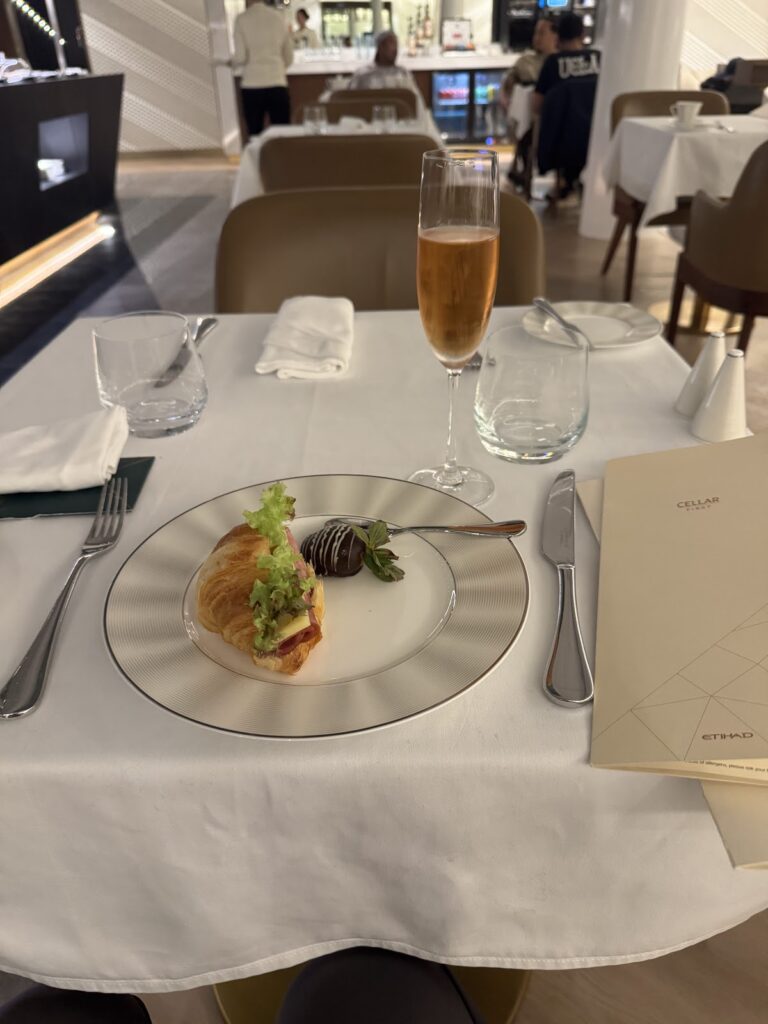 Croissant and champagne at Etihad First Class Lounge dining