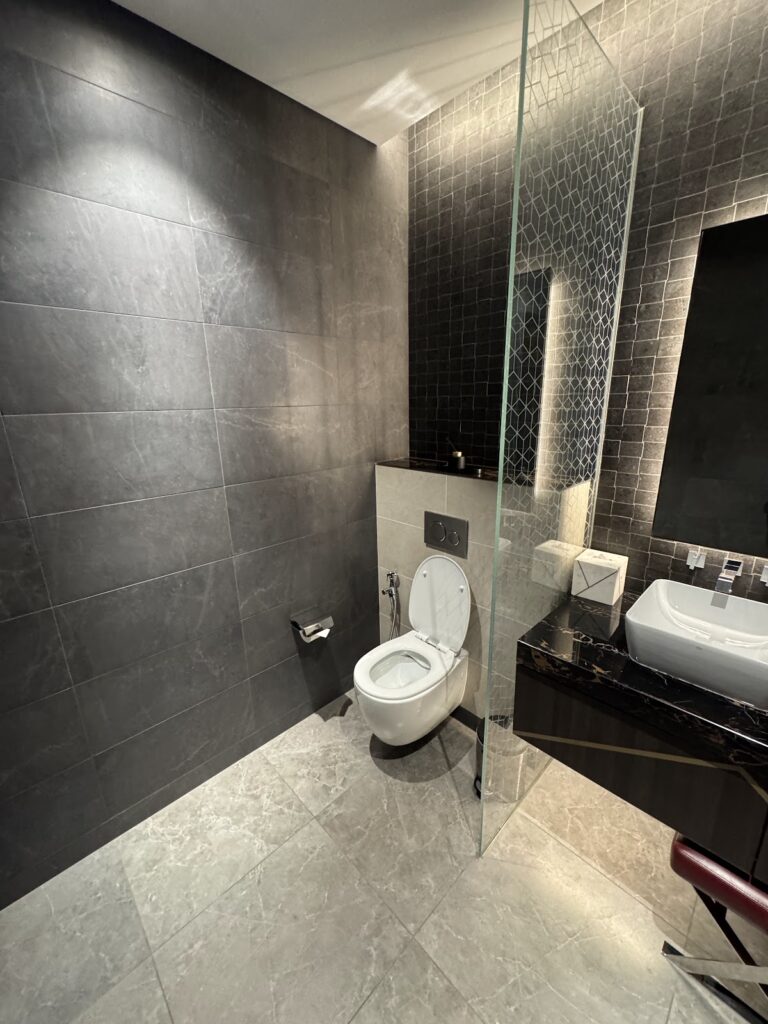 Bathroom with dark marble tiles in Etihad First Class Lounge