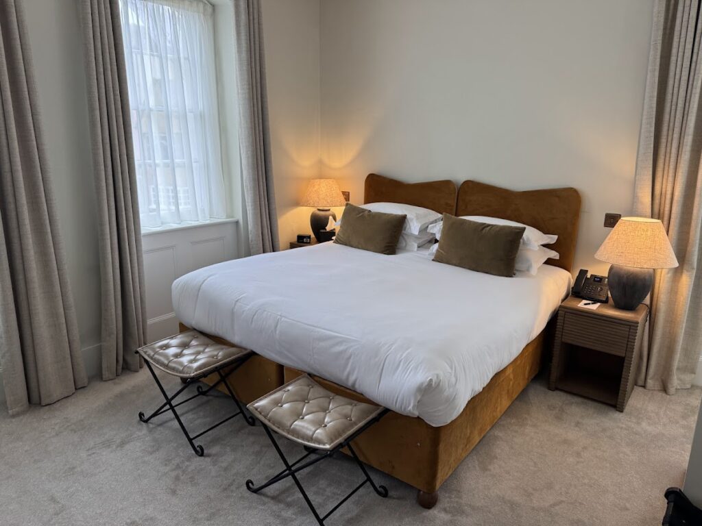 King bed with velvet headboard at The Feathers Woodstock