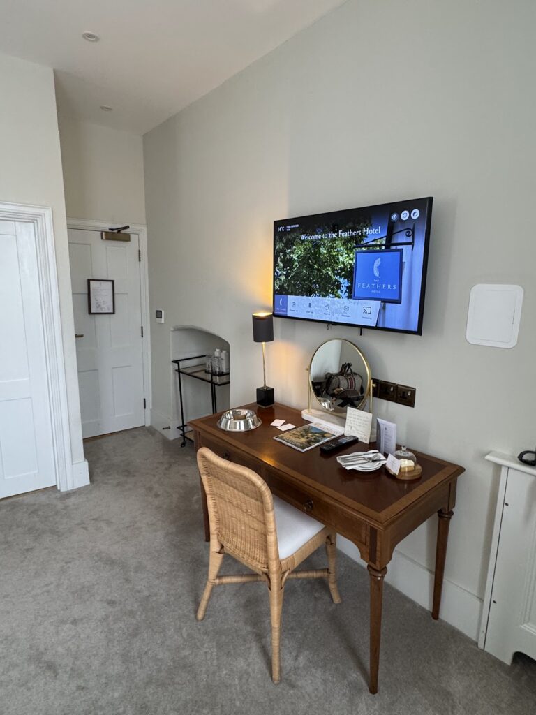 Desk and TV in a Feathers Hotel Woodstock room
