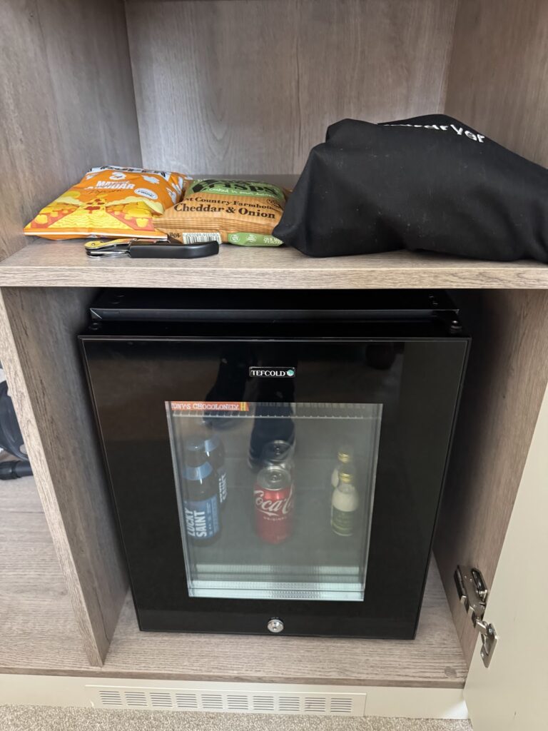 Minibar with snacks and drinks in room