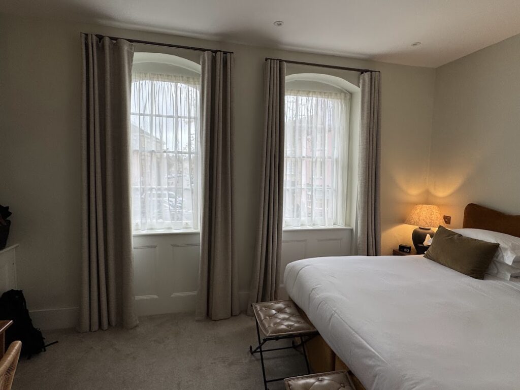 Bedroom with arched windows at The Feathers Hotel Woodstock