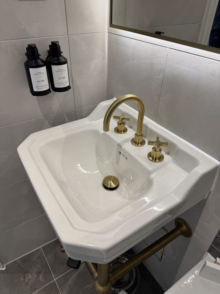 Bathroom sink with brass taps at The Feathers Woodstock
