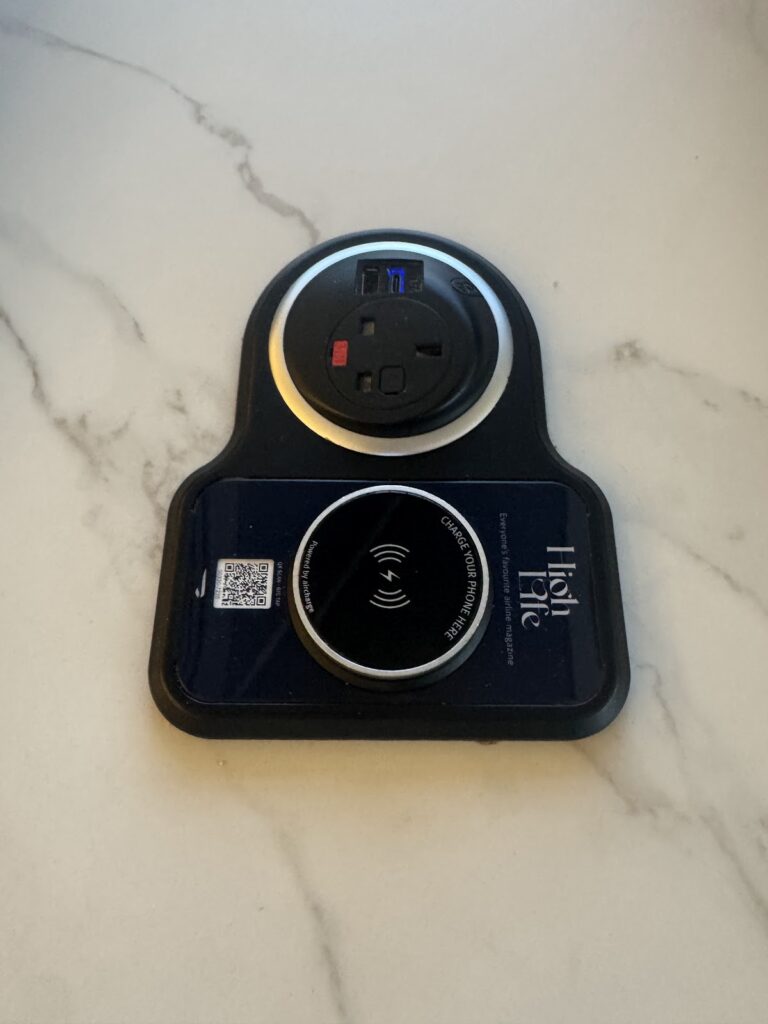Wireless charging pad and power socket in the lounge