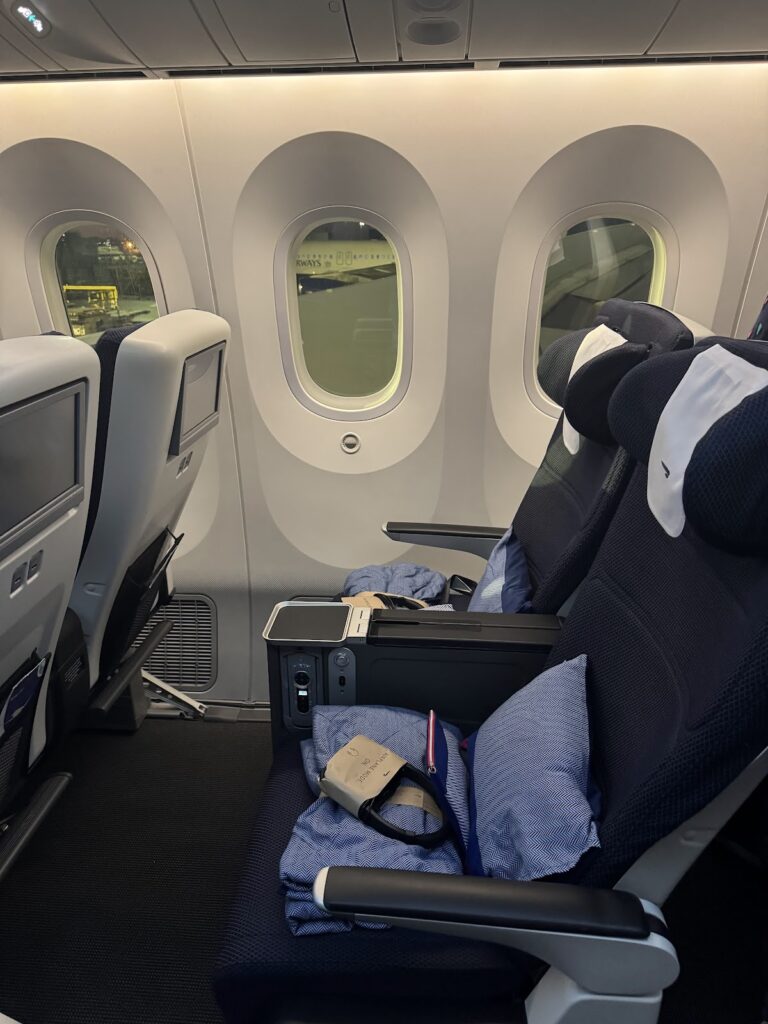 BA premium economy seat with pillow and blanket on 787