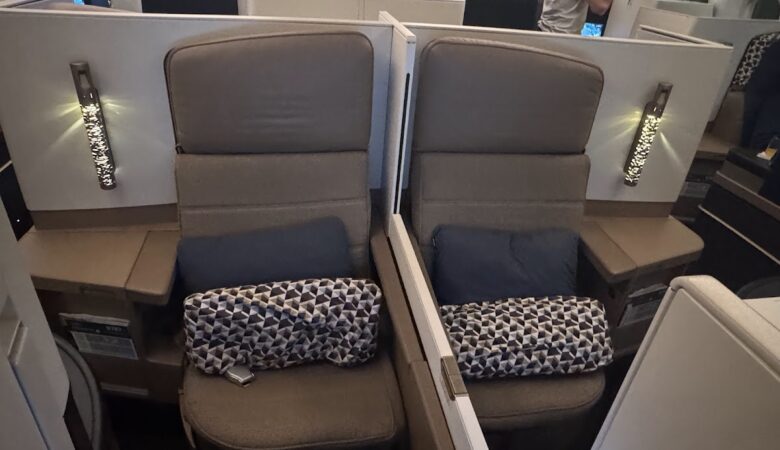 Etihad Business Class centre seats with pillows and blankets