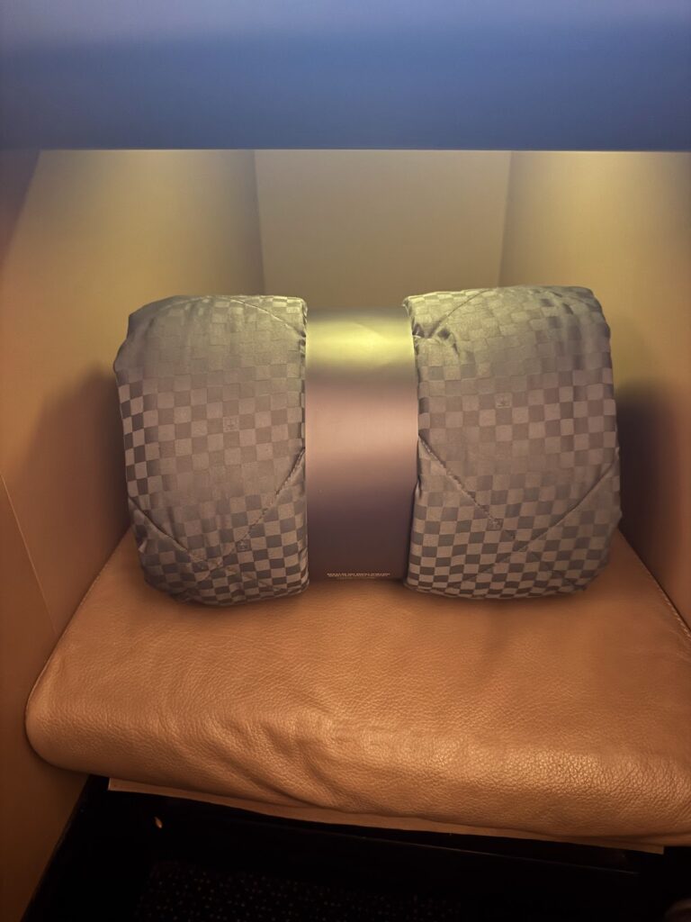 Rolled blanket and pillow in Etihad Business Class suite