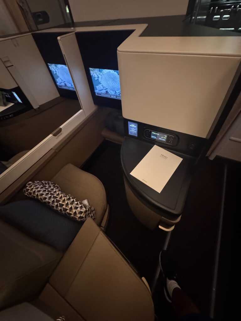 Etihad Business Class seat with IFE screen and menu