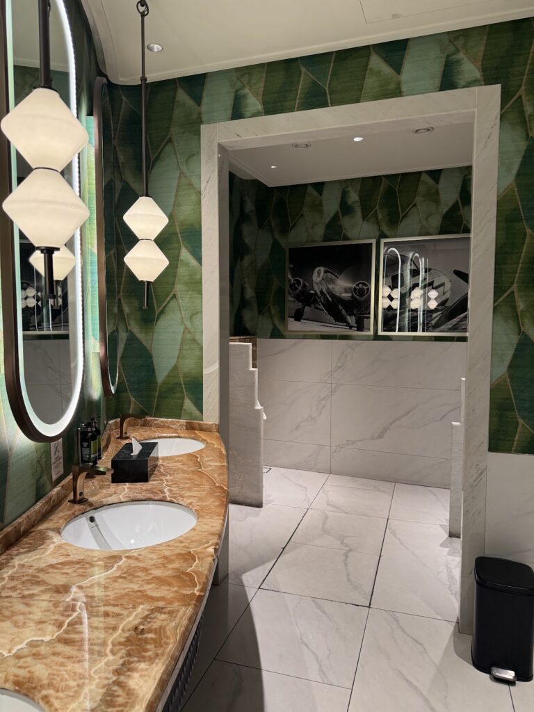 Washroom sinks and aviation artwork at Global Lounge KLIA