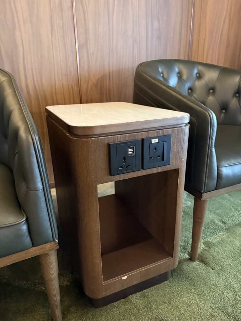 Side table with power outlets in Global Lounge