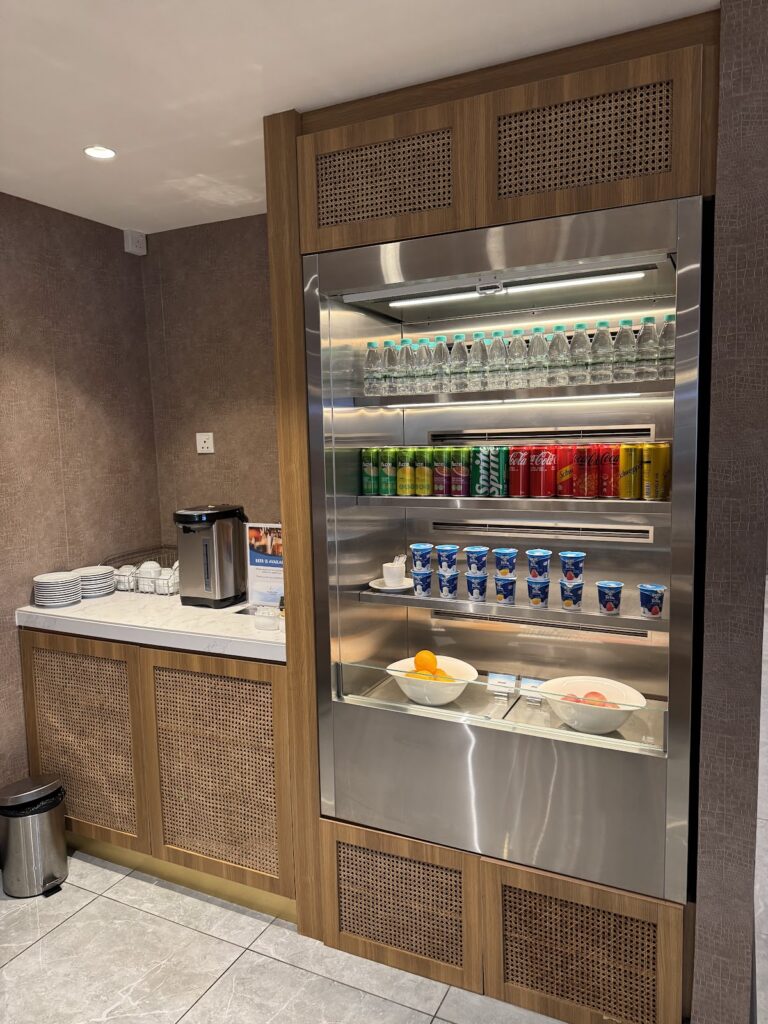 Soft drinks, water, yoghurt, and fruit in refrigerated display