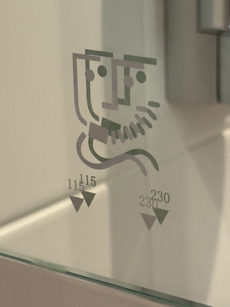 Shaver socket graphic on bathroom mirror glass