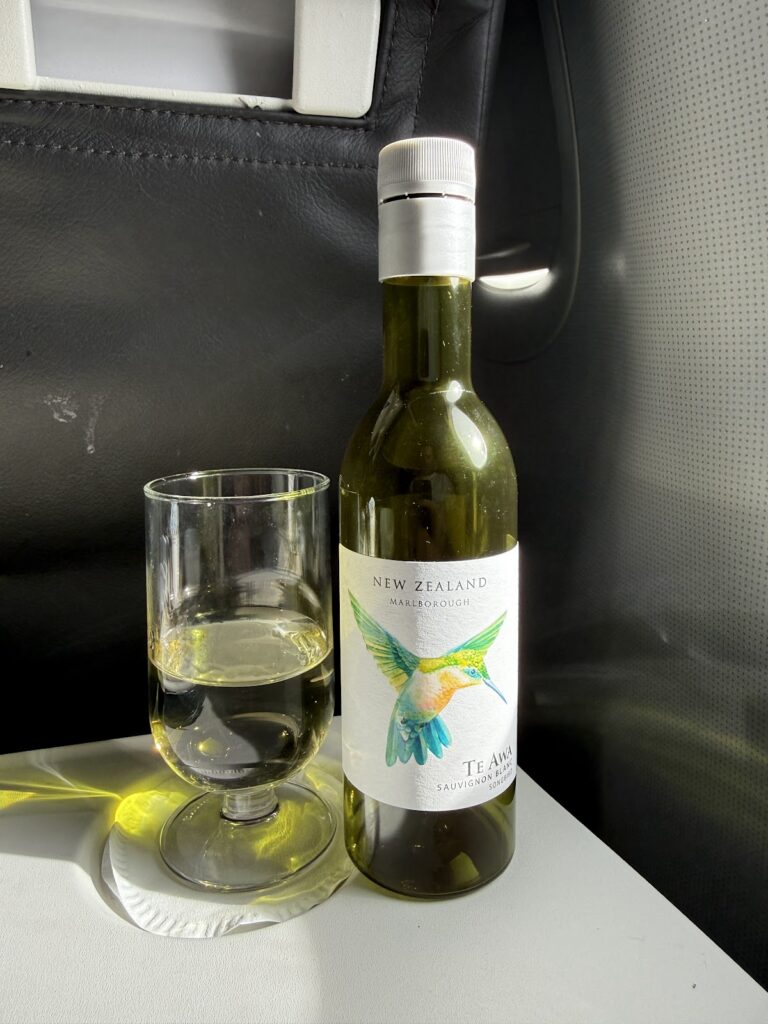 White wine bottle and glass on tray table