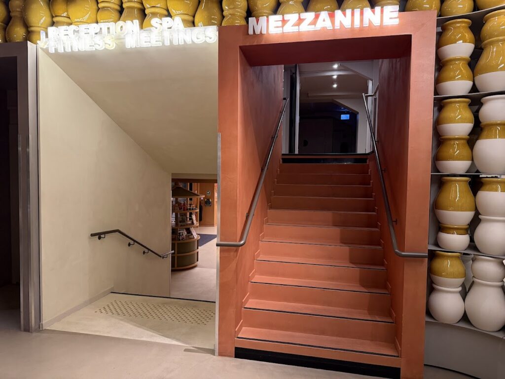Mezzanine staircase beside business meeting entrance