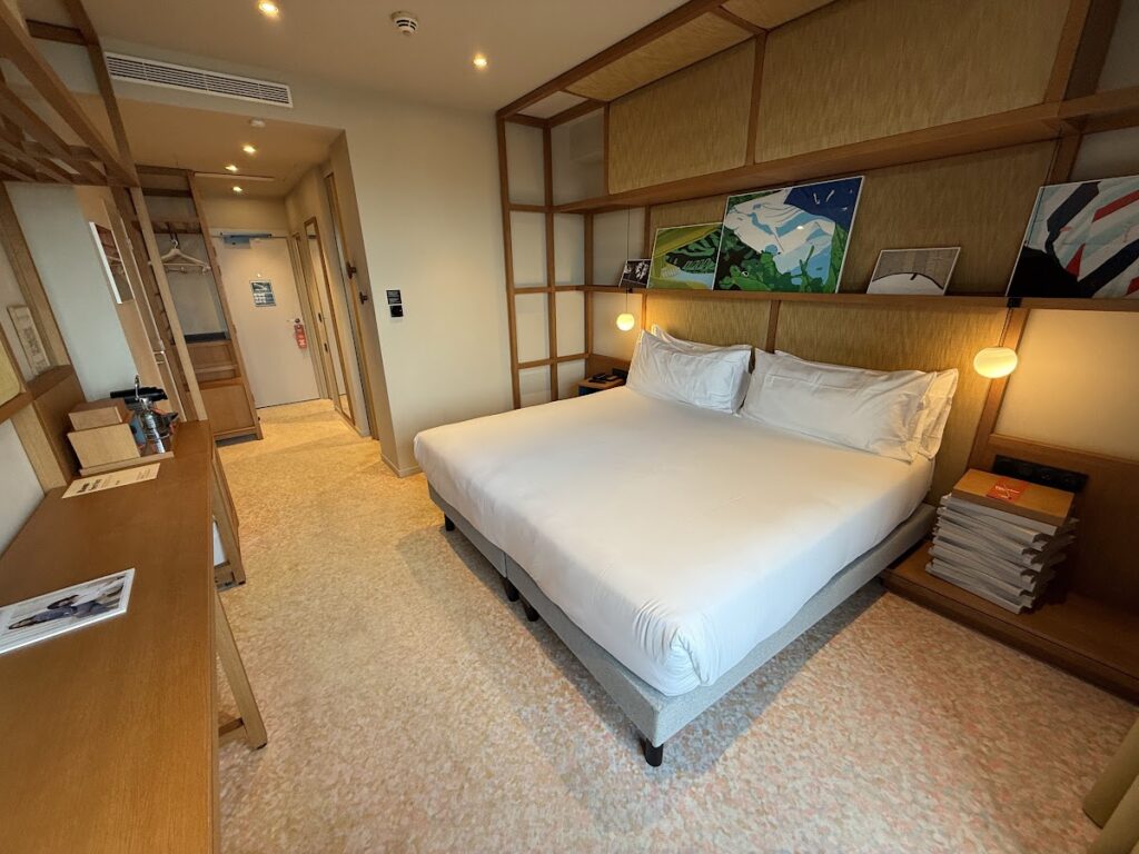 King room with white bed and wood-panelled walls