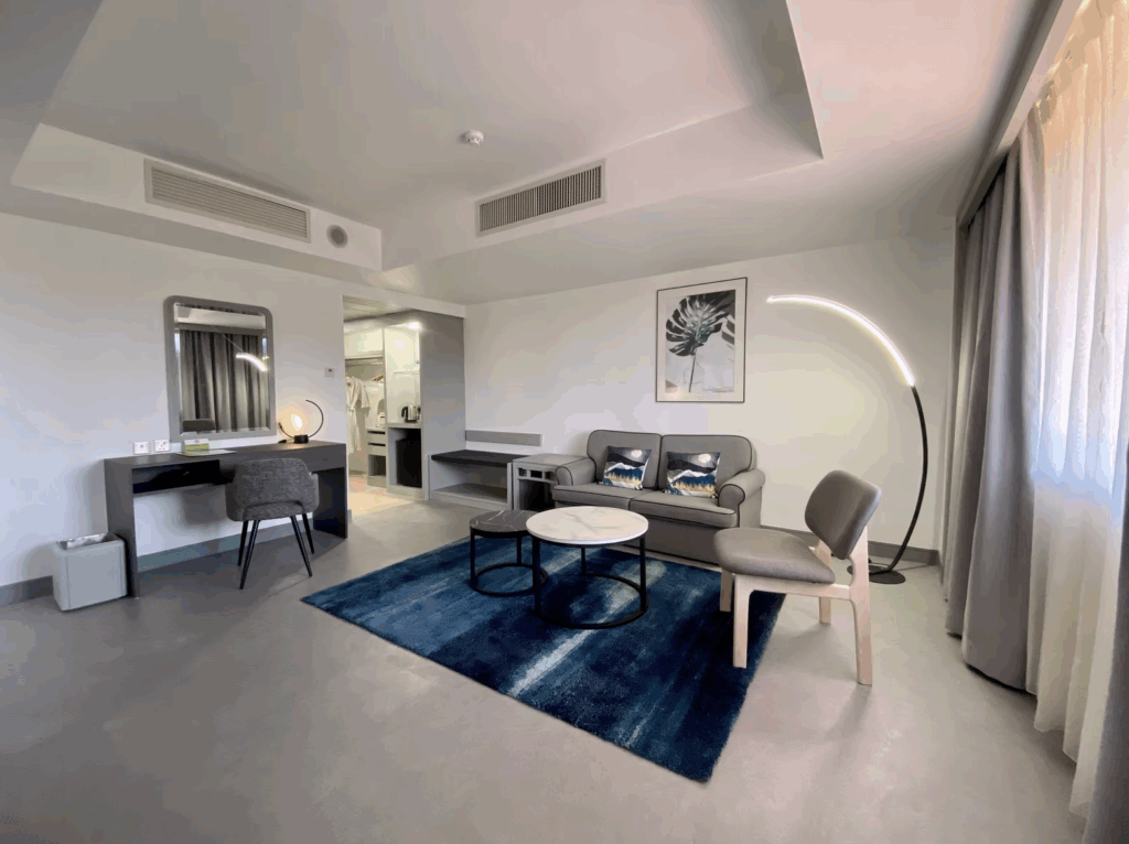 Executive Suite seating area with desk and blue rug