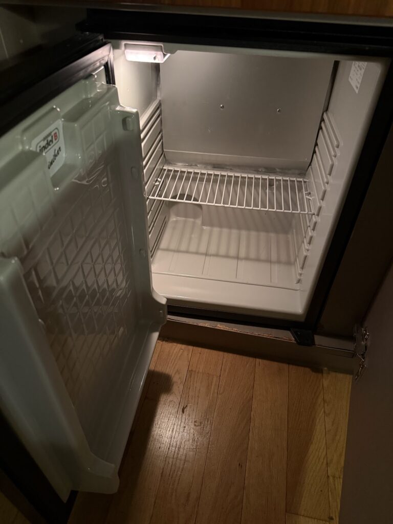 Empty minibar fridge inside the guest room