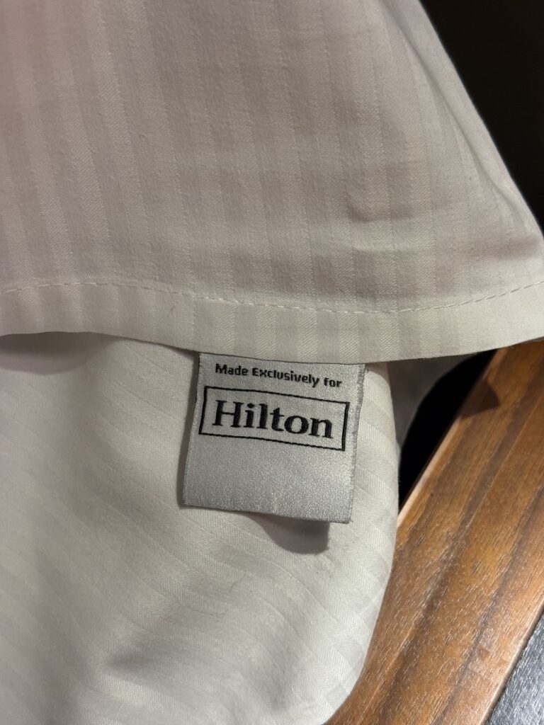 Hilton-branded linen tag in the guest room