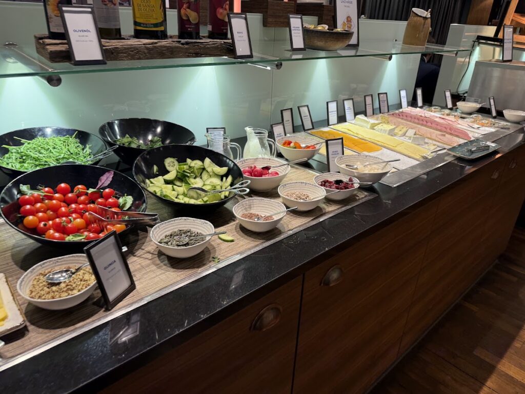 Hilton Cologne breakfast buffet with salads, cheeses, and cold cuts