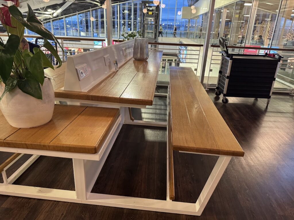 Wooden communal table with bench seating in lounge