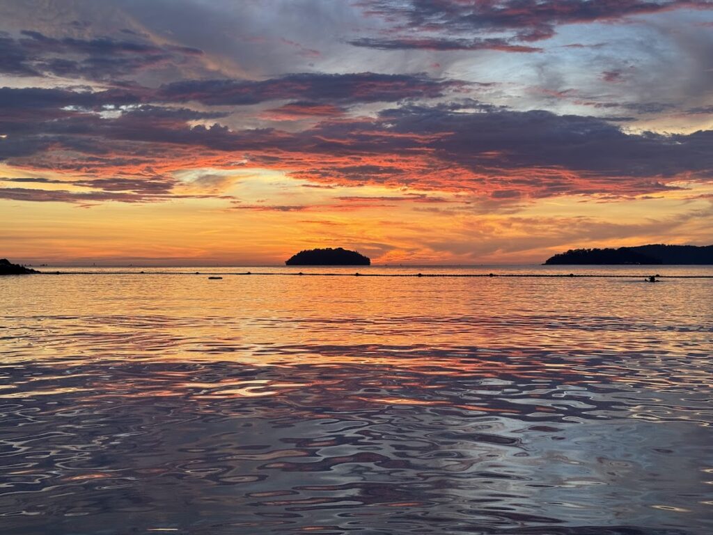 Fiery Kota Kinabalu sunset over calm sea