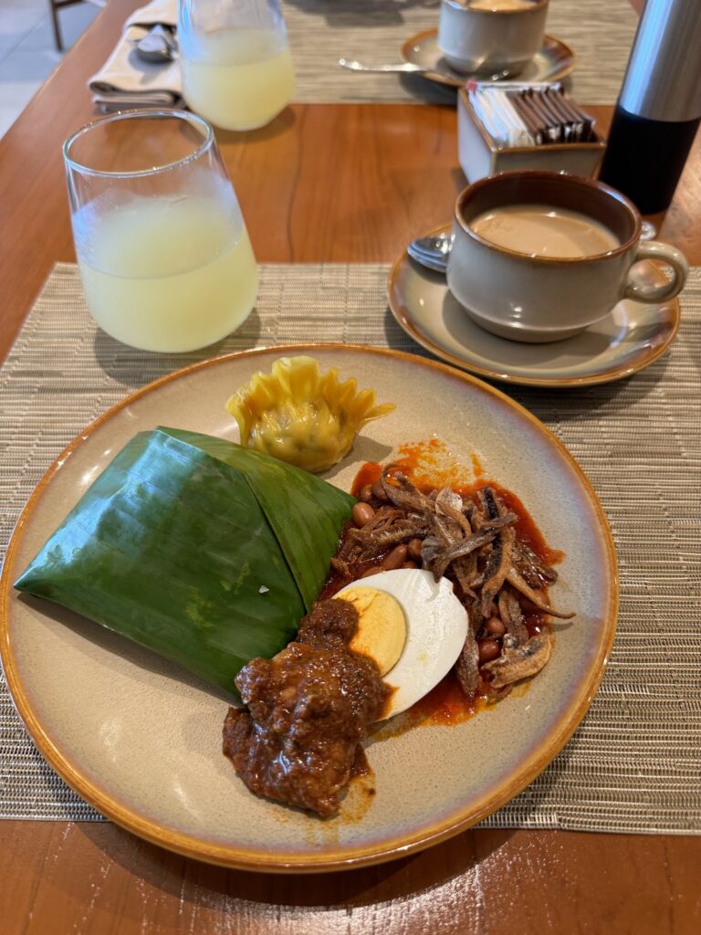 Nasi lemak breakfast with coffee and juice