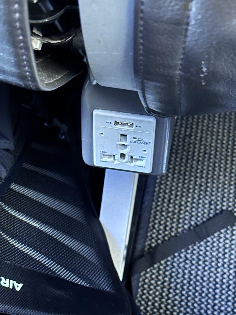 Seat power socket beneath BA A320 seat