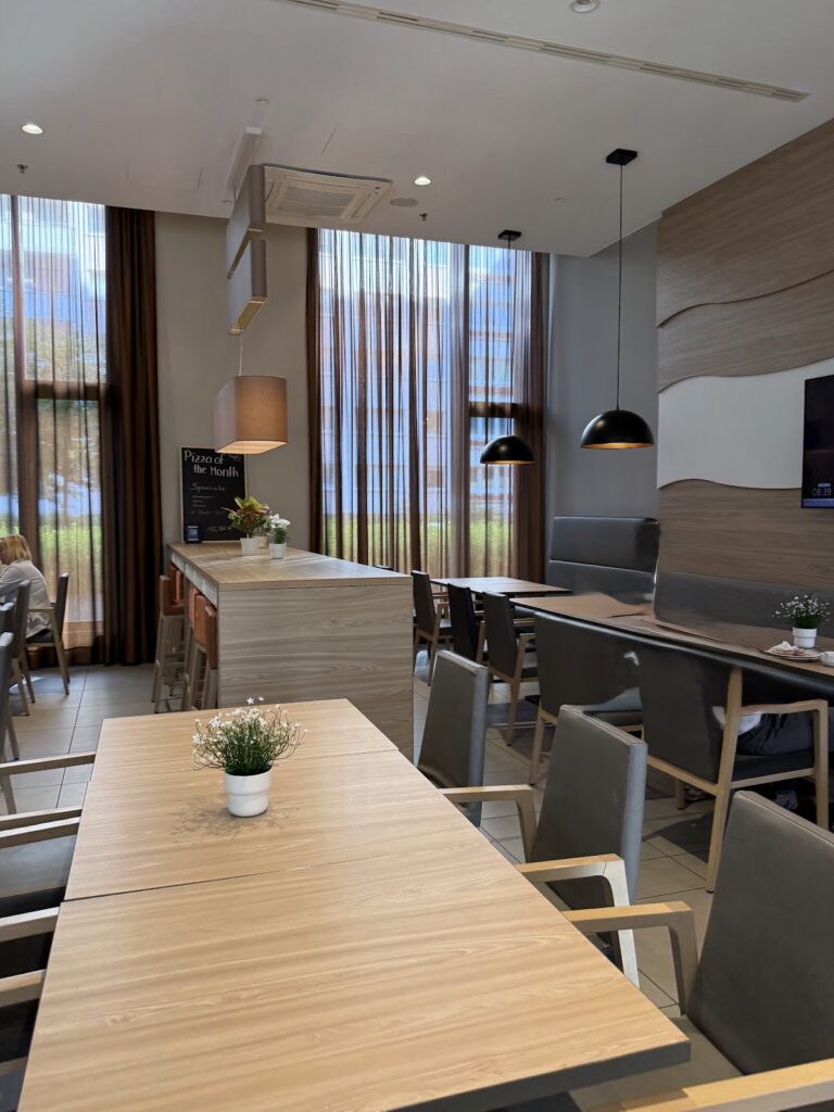 Bright dining area with tables and tall windows