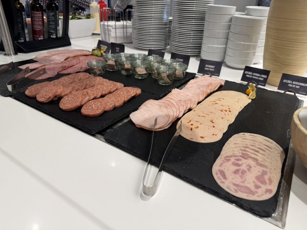 Cold meats laid out on breakfast buffet