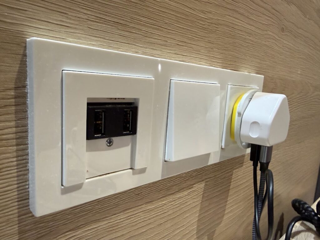 Wall sockets and USB ports beside bed