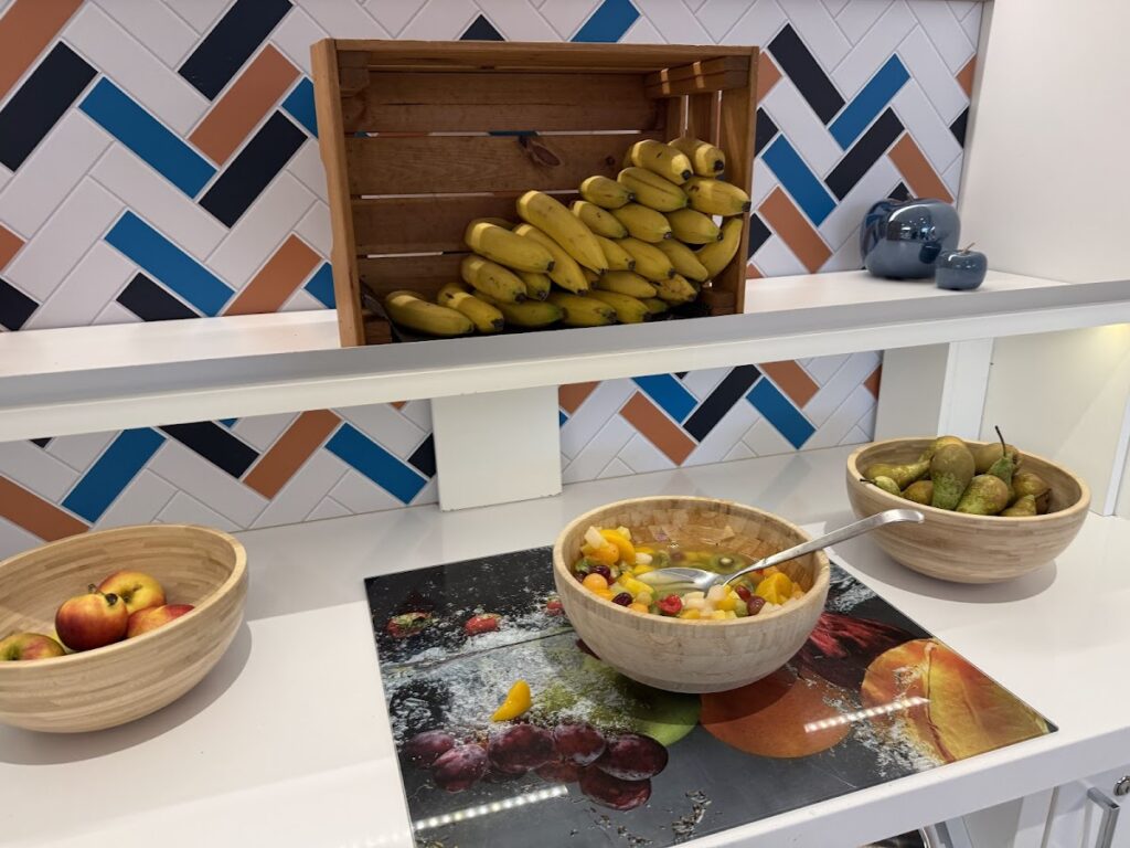 Breakfast fruit display with bananas, apples, pears, and salad