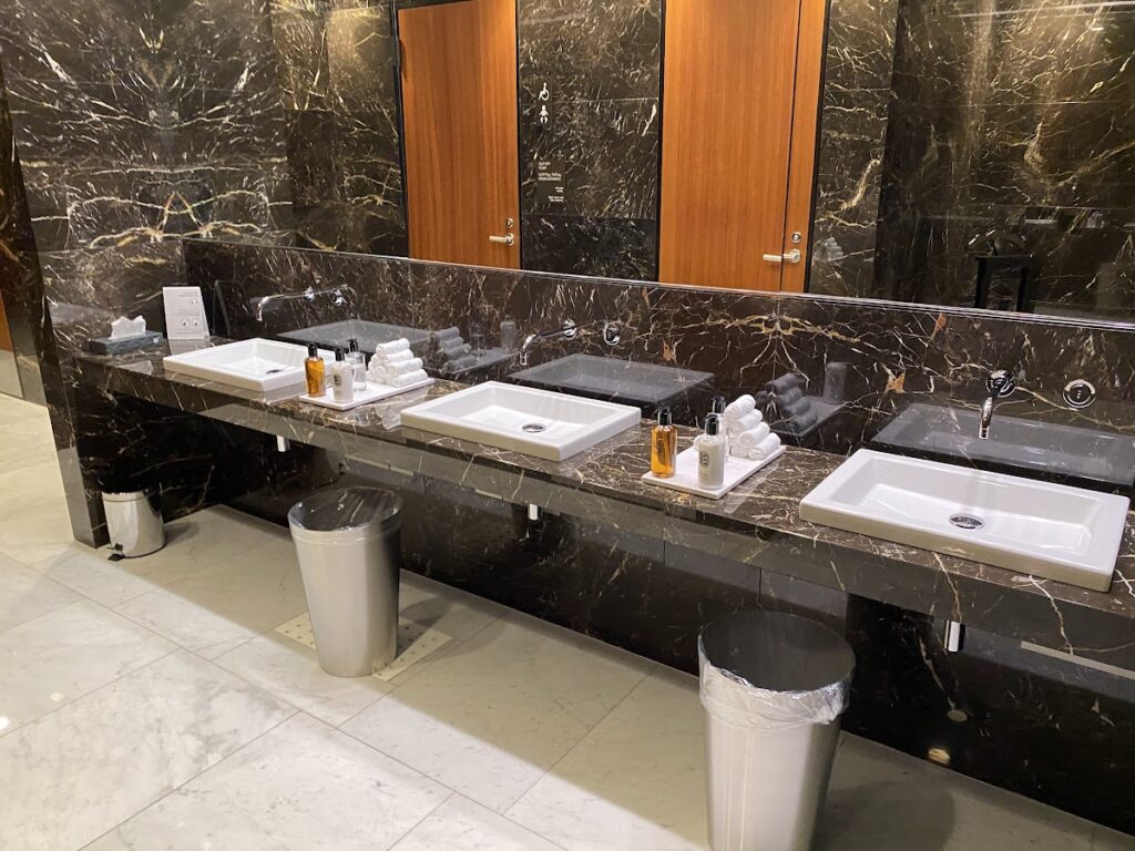 Marble restroom vanity with multiple sinks