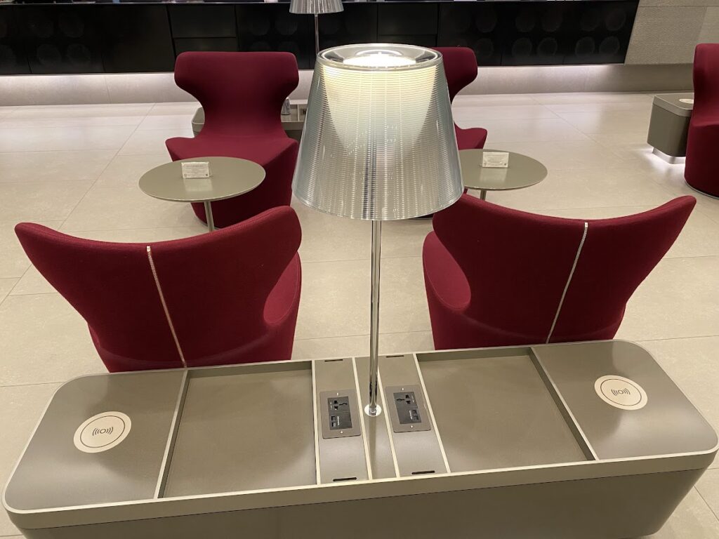 Red chairs inside Al Mourjan Lounge Doha seating area