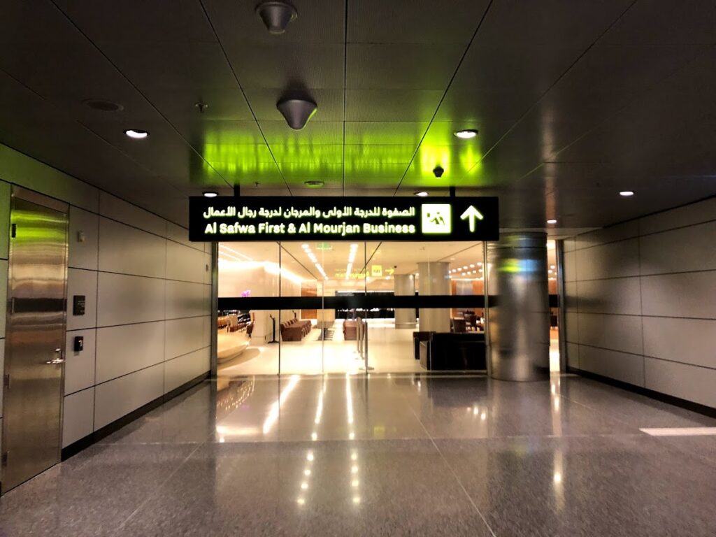 Entrance sign for Al Mourjan Lounge Doha in terminal corridor