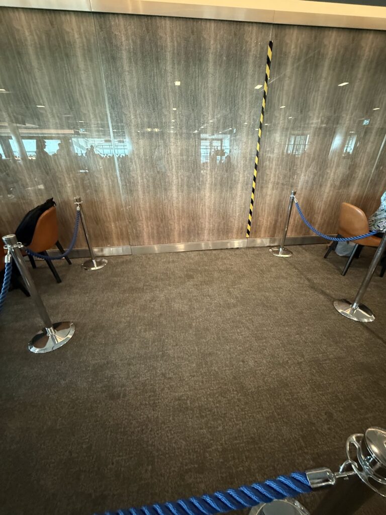 Roped-off lounge area behind temporary screening