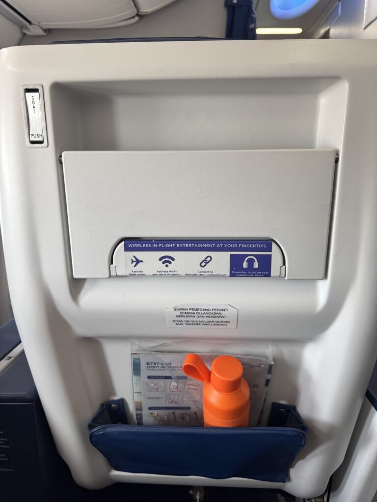 Business Class seatback with wireless entertainment card and bottle