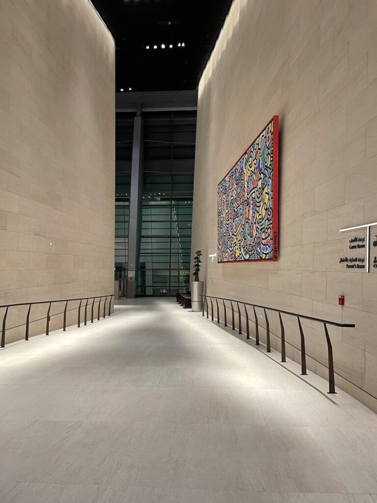 Tall corridor with artwork inside Al Safwa lounge