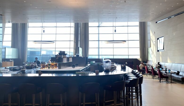 Bar seating and dining area with airport views