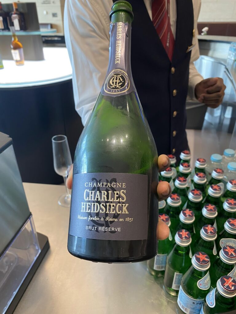 Staff presenting Charles Heidsieck champagne bottle