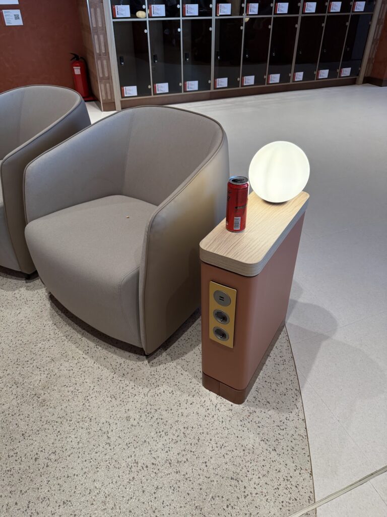 Armchair beside side table with power sockets